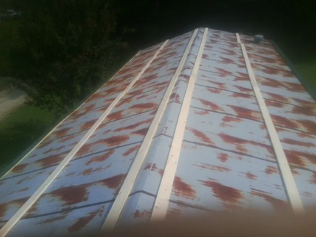 Rusted metal roof panels with new wood purlins before replacement — Storm Damage Roof Repair in Wallops Island by Roofing Brothers